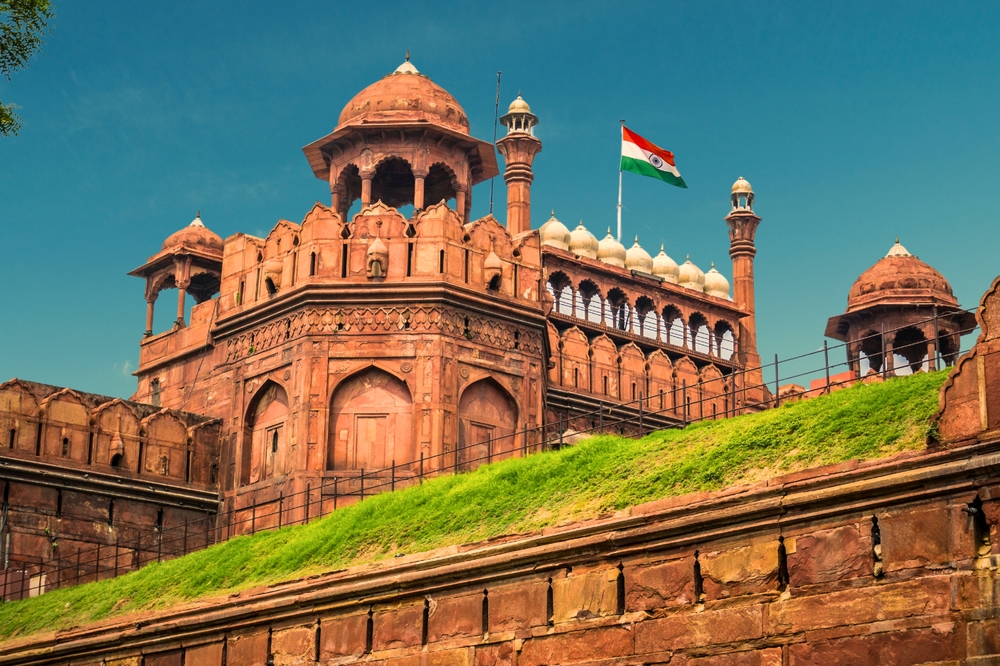 RED FORT DELHI INDIA WITH INDIA FLAG FLYING HIGH.