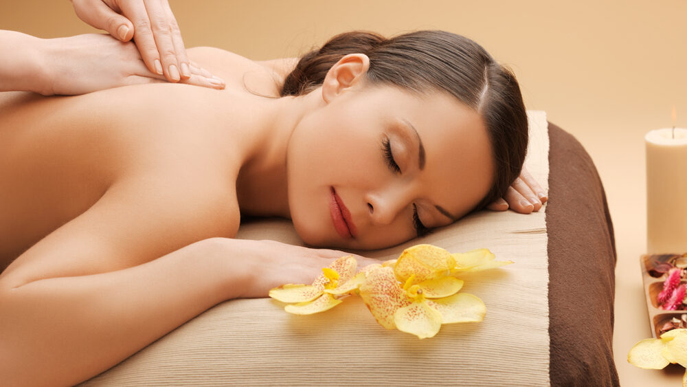 Young women having massage in the spa of a luxury hotel representing the amenities that hotels provide